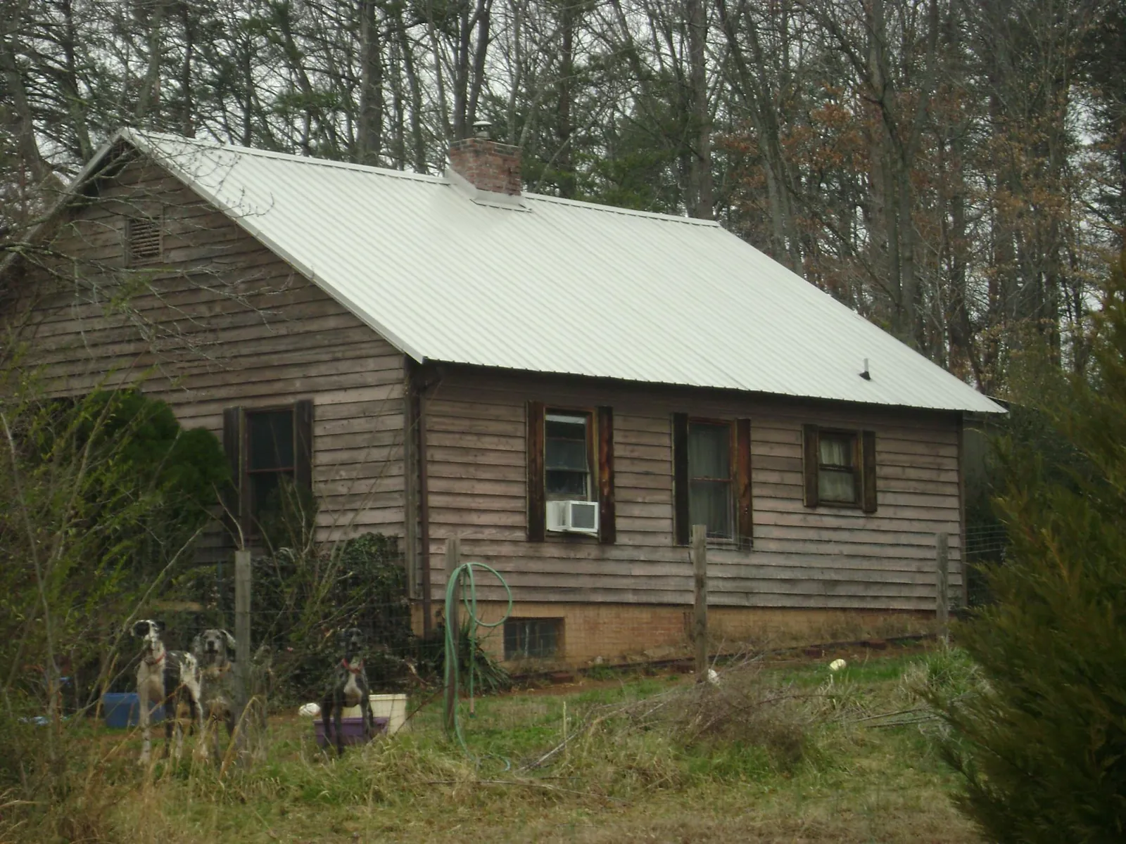 White metal roof on an old wood sided farmhouse, from a Metal Roof Installation job in Platte Center